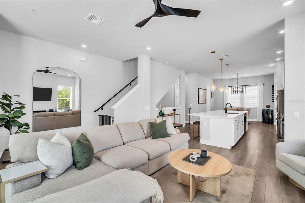 An open-concept living room and kitchen featuring a large sectional sofa and white island — 2851 1ST AVENUE S, ST PETERSBURG, FL