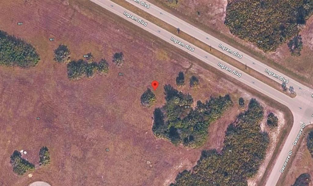 This is an aerial map view of a vacant, grassy lot near a road — 313 INGRAM BOULEVARD, ROTONDA WEST, FL