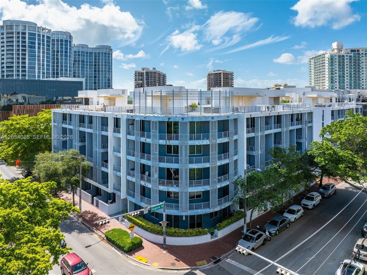 An aerial view of a modern multi-story apartment building at a street corner intersection — 3339 Virginia St # 22, Miami FL 33133, MIAMI, FL