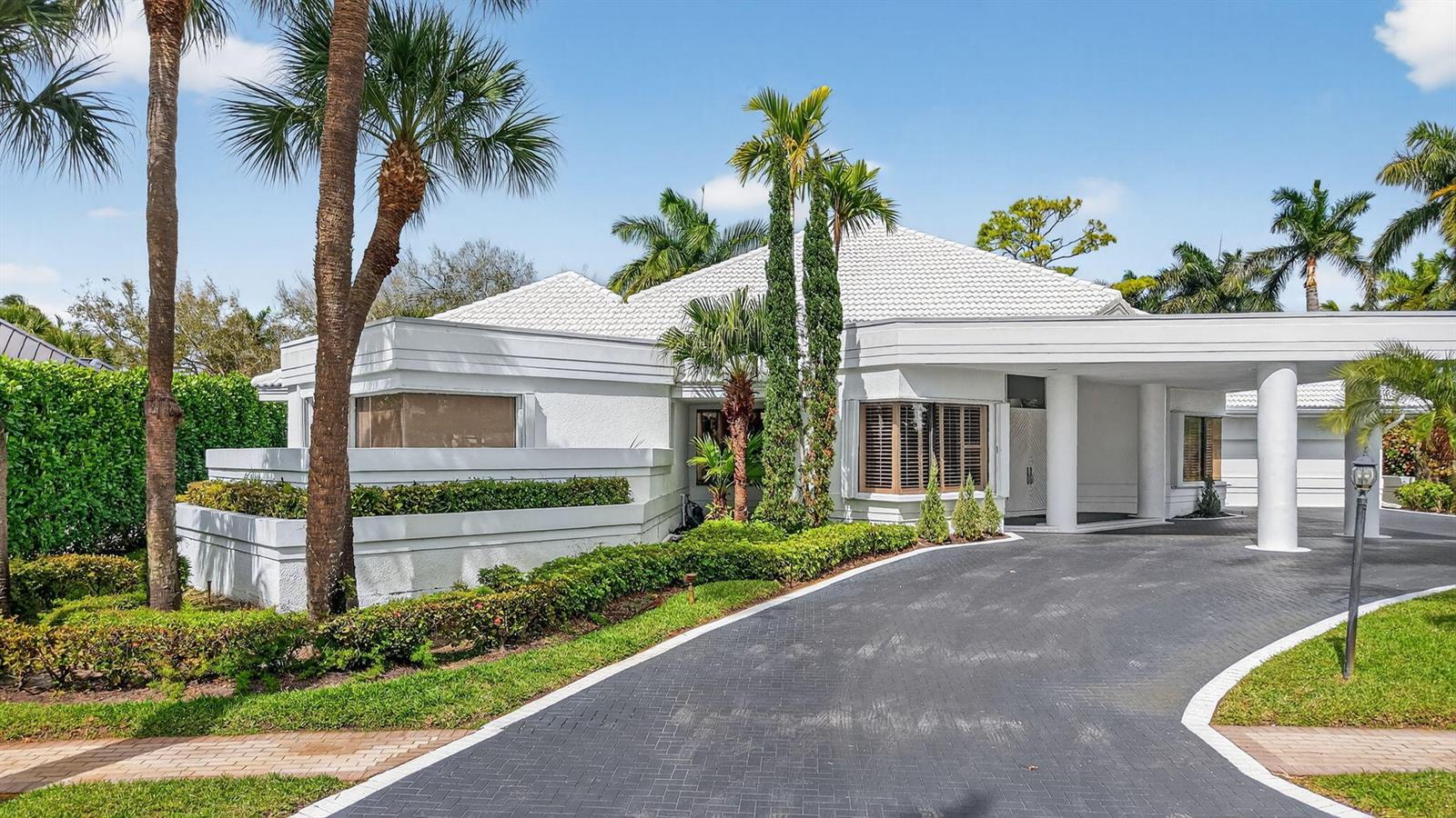 A white house with a tiled roof and a paved driveway surrounded by palm trees — 7215 Ballantrae Court, Boca Raton FL 33496, BOCA RATON, FL