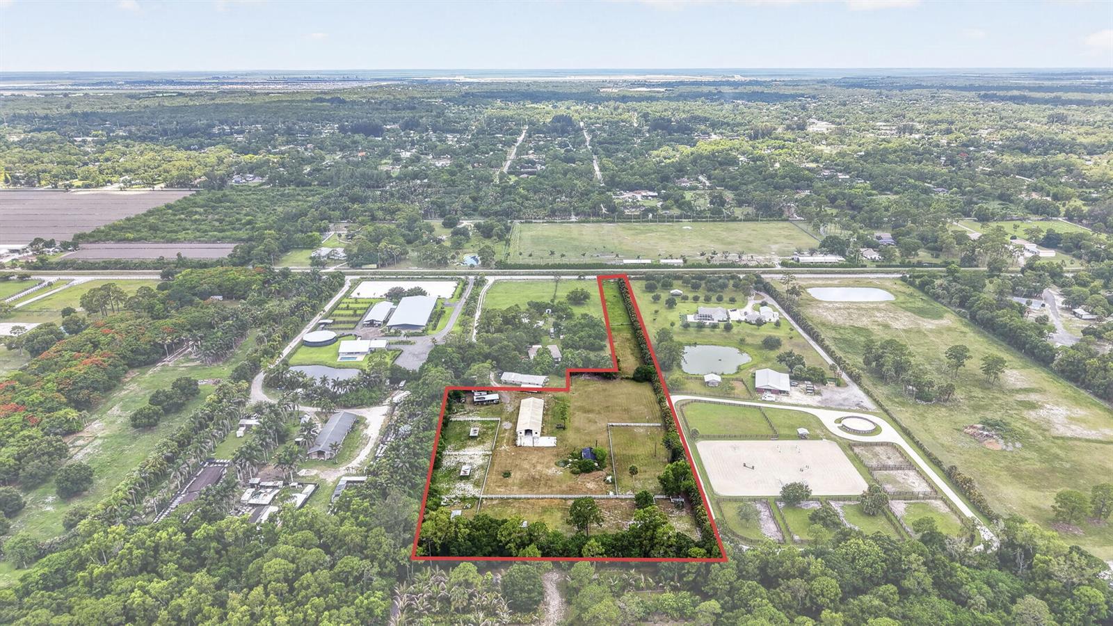An aerial view shows a fenced rural property with a house and outbuildings — 2944 A Road, Loxahatchee FL 33470, LOXAHATCHEE, FL