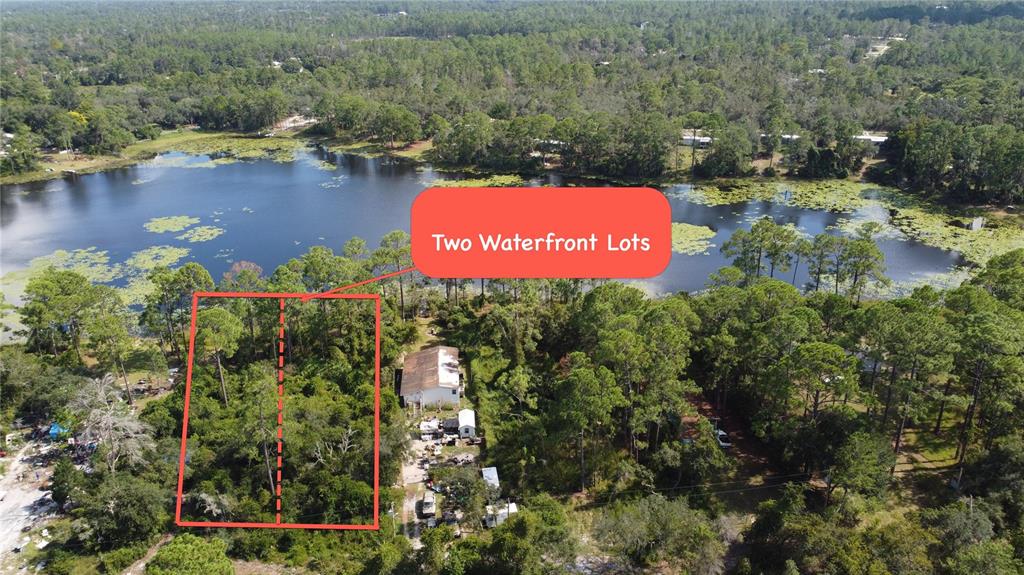 An aerial view shows two wooded waterfront lots located next to a small house — W LAKE ROAD, DELAND, FL