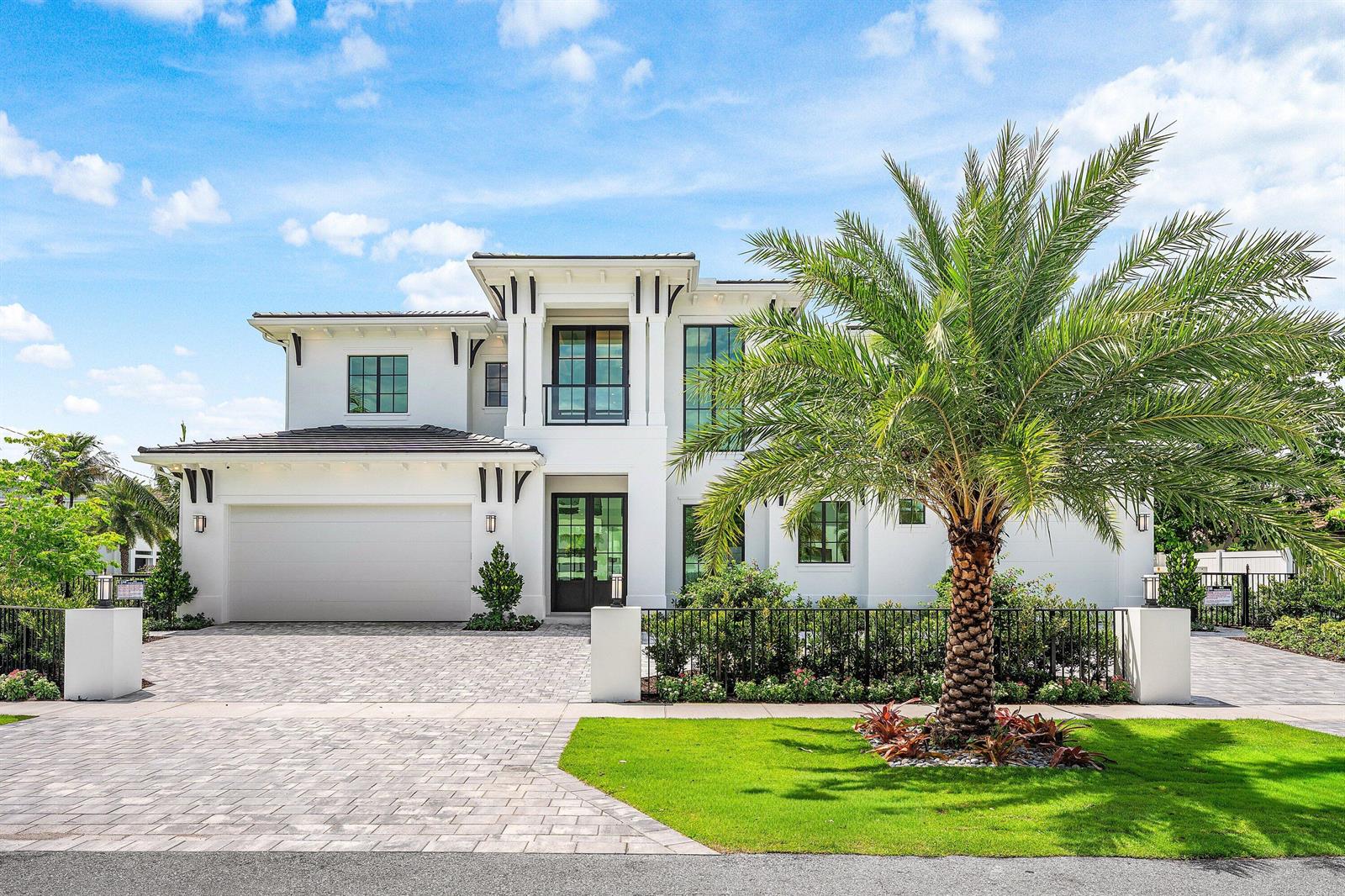 A two-story white modern house features a paved driveway, a palm tree, and black-framed windows — 201 NE 4th Avenue, Boca Raton FL 33432, BOCA RATON, FL