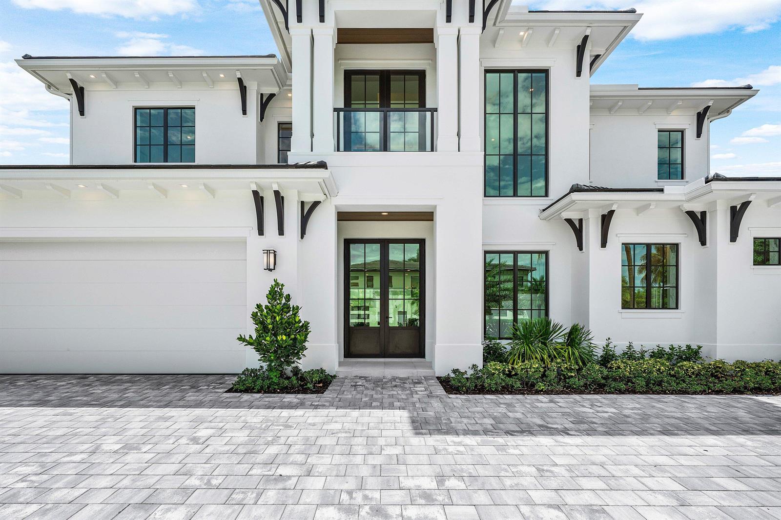 A modern two-story white house features a paved driveway, dark-framed windows, and a glass balcony — 201 NE 4th Avenue, Boca Raton FL 33432, BOCA RATON, FL