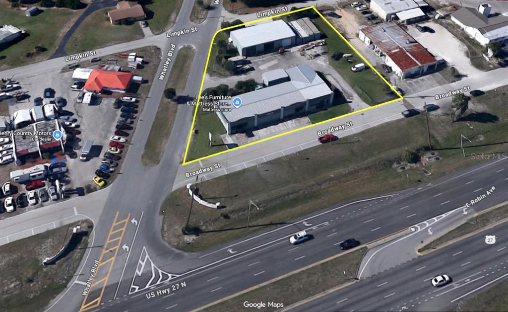 An aerial view shows a commercial property outlined in yellow at a street intersection — 32379 BROADWAY STREET, SEBRING, FL
