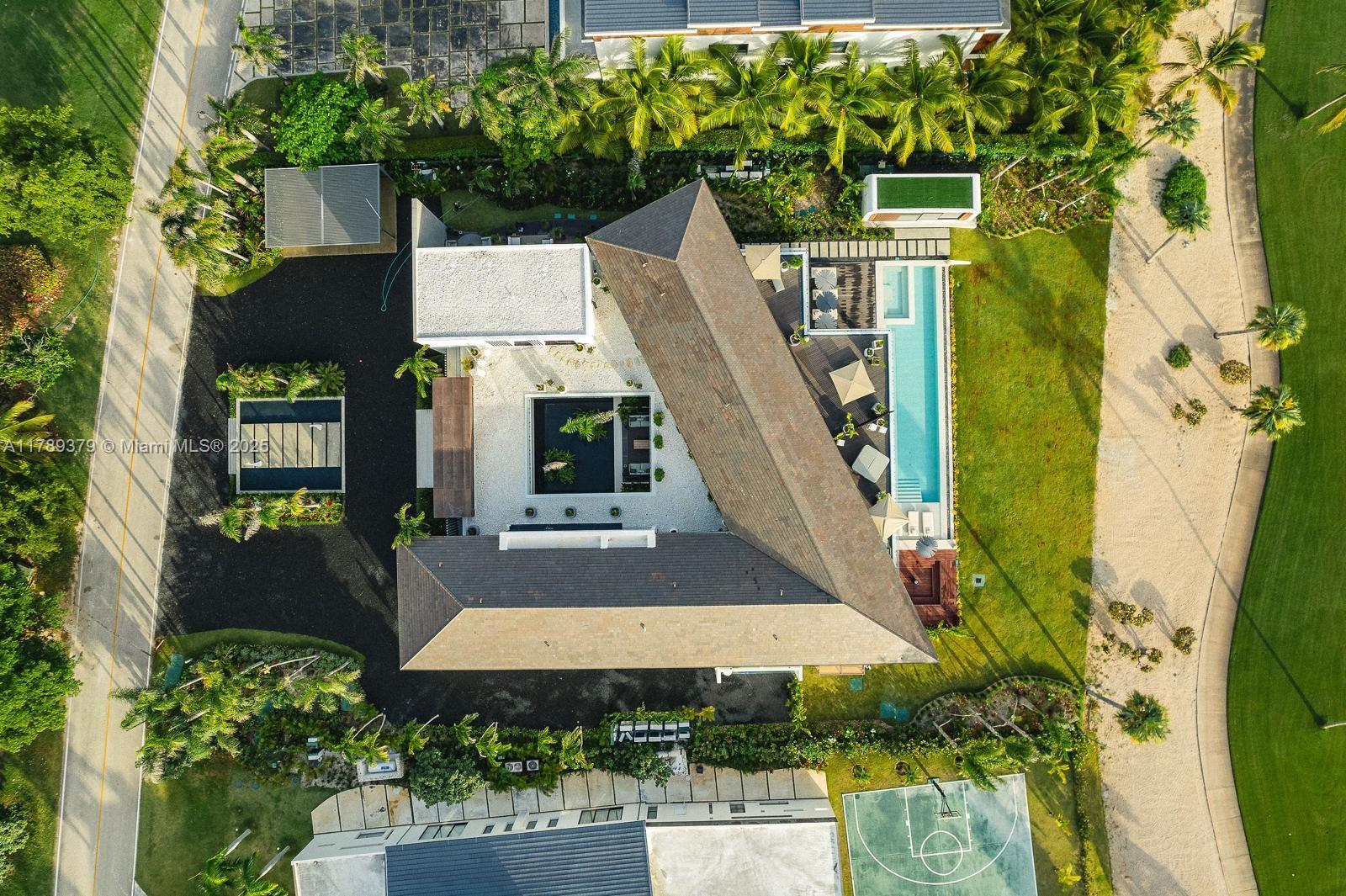 An aerial view shows a modern house with a central courtyard and a lap pool — 000 154 Cap Cana 23000, Dominican Republic, DR, DR