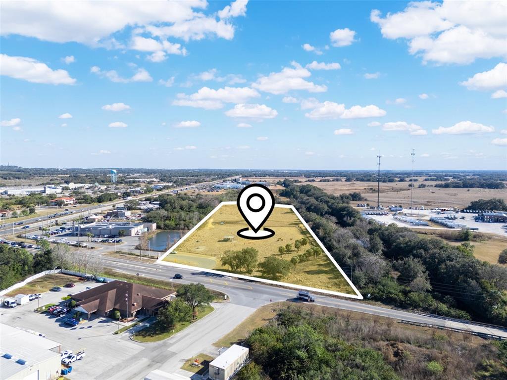 An aerial view shows a vacant, trapezoidal plot of land marked with a location pin — THOMPSON NURSERY ROAD, LAKE WALES, FL