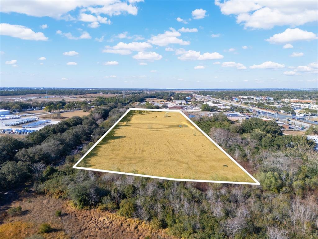 An aerial view shows a rectangular, grass-covered plot of land outlined in white — THOMPSON NURSERY ROAD, LAKE WALES, FL