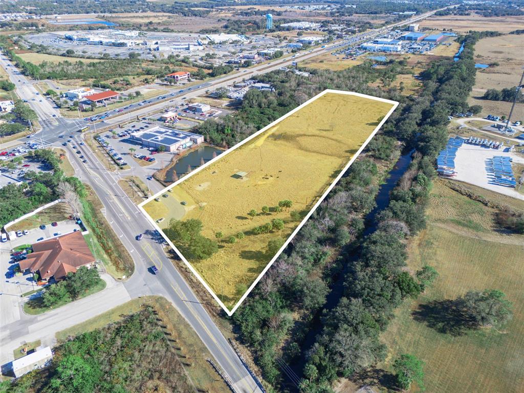 An aerial view shows a large, rectangular vacant lot outlined in white next to a road — THOMPSON NURSERY ROAD, LAKE WALES, FL