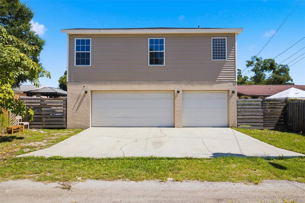 A two-story building with a two-car garage and a concrete driveway — 2462 14TH AVENUE N, ST PETERSBURG, FL