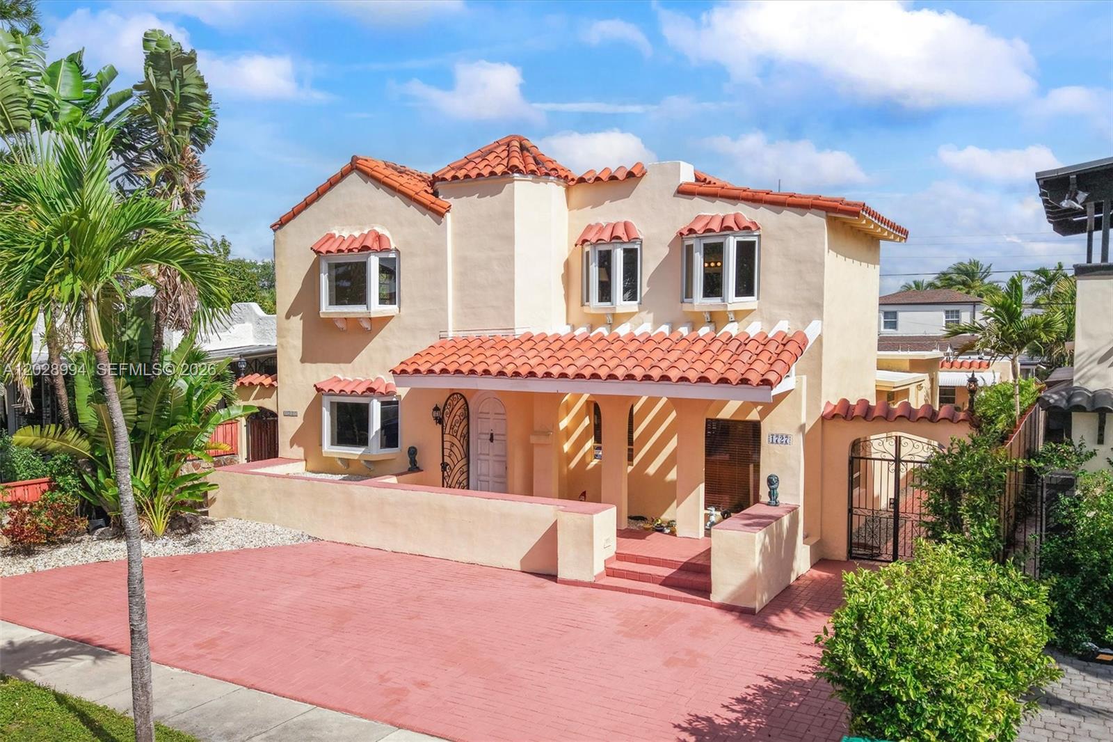 A two-story Mediterranean-style house features a red tile roof, stucco walls, and a paved driveway — 1727 SW 11th Ter, Miami FL 33135, MIAMI, FL