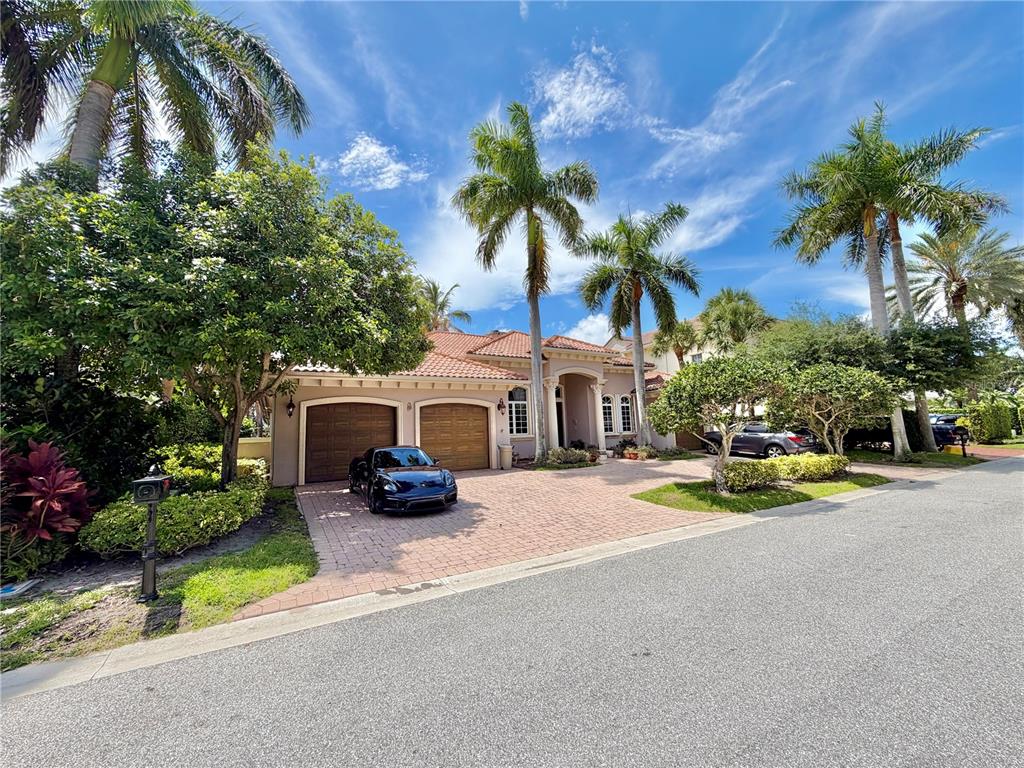 An aerial view of a waterfront house with a swimming pool, patio, and private boat dock — 785 HARBOUR ISLE PLACE, NORTH PALM BEACH, FL