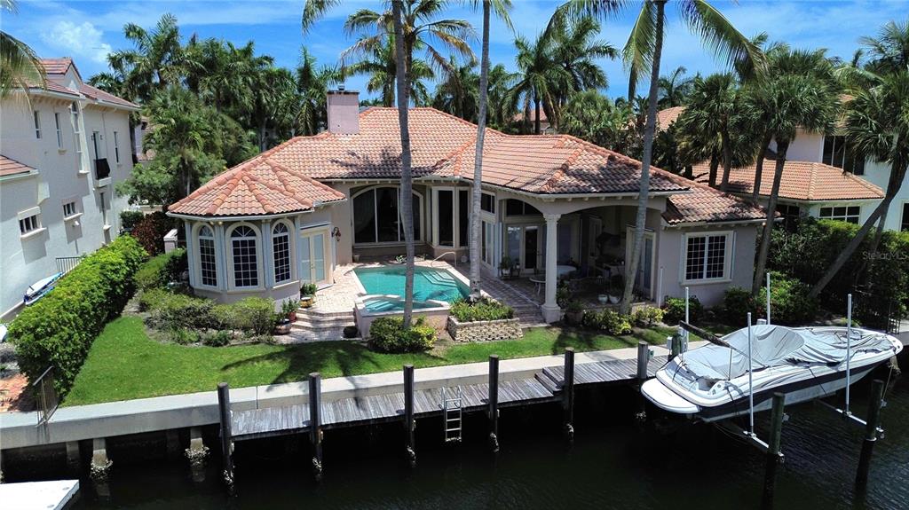 A single-story house with a tile roof, two-car garage, and palm trees in the front yard — 785 HARBOUR ISLE PLACE, NORTH PALM BEACH, FL