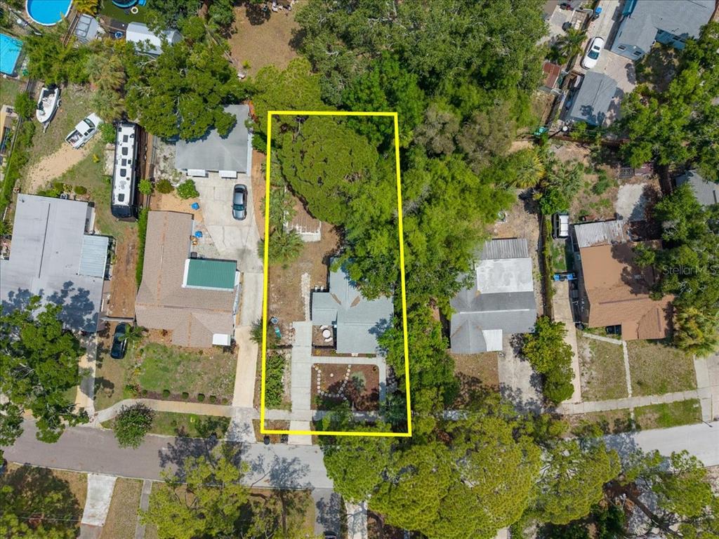 An aerial view shows a house with a yard outlined in yellow on a residential street — 745 ALAMANDA WAY S, ST PETERSBURG, FL