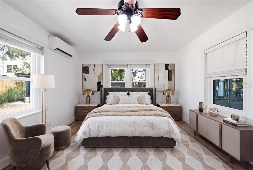 A bedroom features a bed with a gray headboard, a ceiling fan, and a rug — 745 ALAMANDA WAY S, ST PETERSBURG, FL