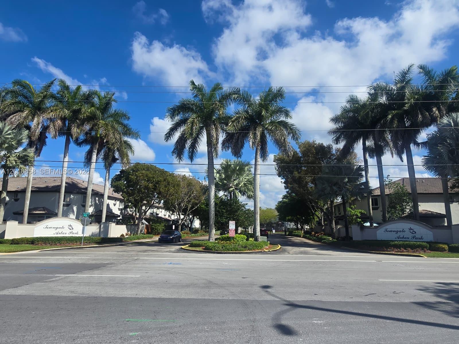 An exterior view of the Towngate Arbor Park entrance with palm trees and signage — 1987 SE 23rd Rd, Homestead FL 33035, HOMESTEAD, FL