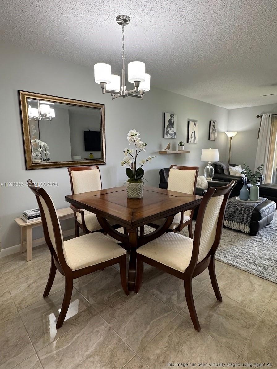 A dining area with a square wooden table, four chairs, and a large wall mirror — 7269 Golf Colony Ct # 202, Lake Worth FL 33467, LAKE WORTH, FL