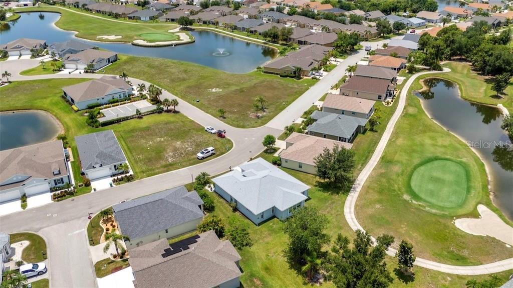 An aerial view shows suburban houses surrounding a golf course with multiple ponds — 24312 WESTGATE BOULEVARD, PUNTA GORDA, FL