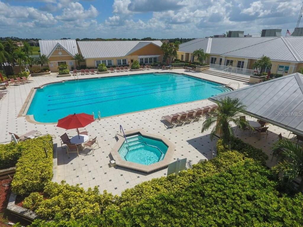 An aerial view of a community swimming pool and hot tub surrounded by lounge chairs — 24312 WESTGATE BOULEVARD, PUNTA GORDA, FL