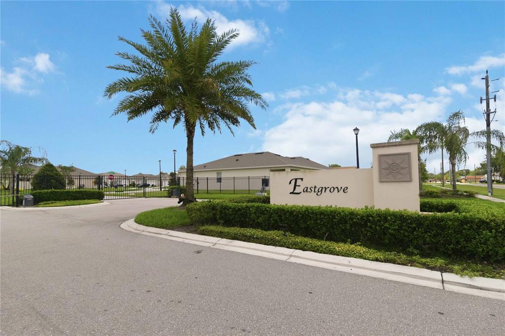 A palm tree stands next to a beige monument sign for the Eastgrove residential community — 3198 EASTGROVE TERRACE, SANFORD, FL