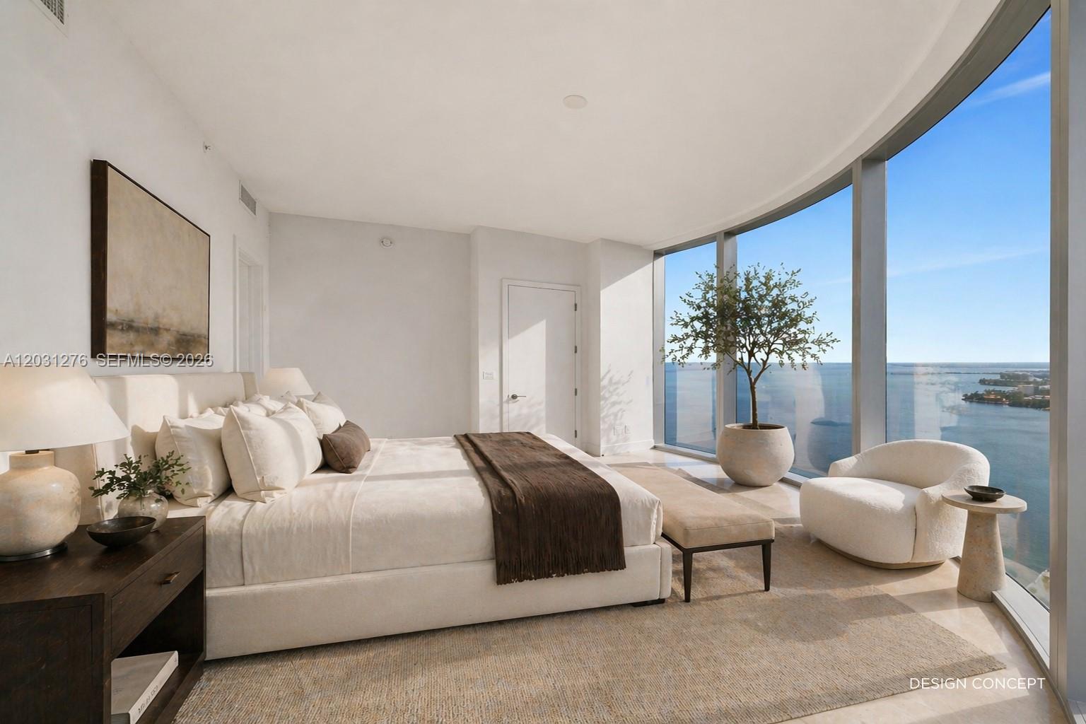 A bedroom features a large bed, floor-to-ceiling windows with water views, and a potted tree — 175 SE 25 Rd # 3403, Miami FL 33129, MIAMI, FL