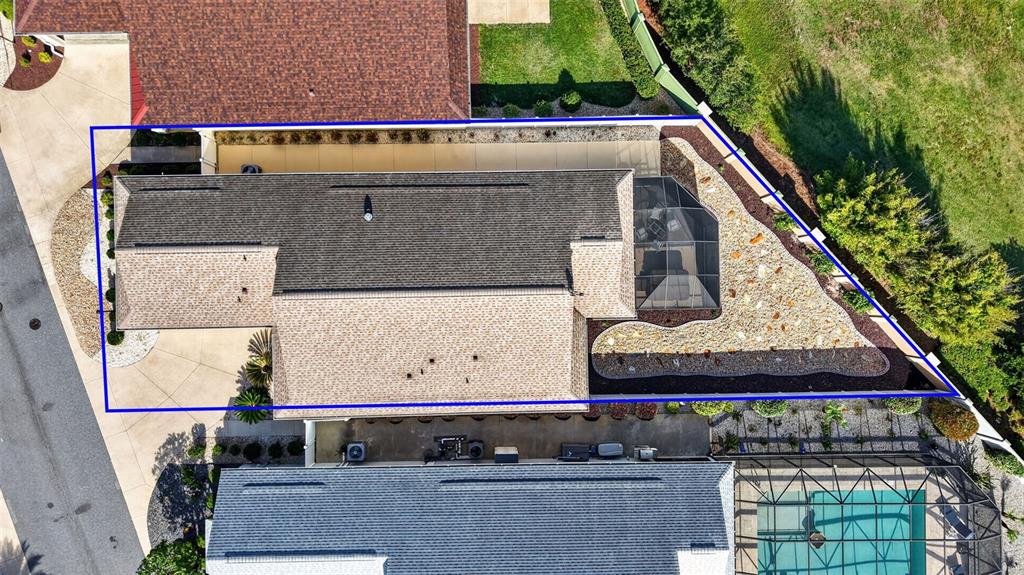 Aerial view of a residential property featuring a house with a screened-in patio — 2873 CHARLEVOIX STREET, THE VILLAGES, FL