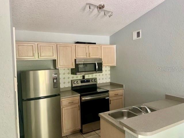 A three-story apartment building features a central stairwell, screened balconies, and a grassy lawn — 8939 LATREC AVENUE UNIT 1307, ORLANDO, FL
