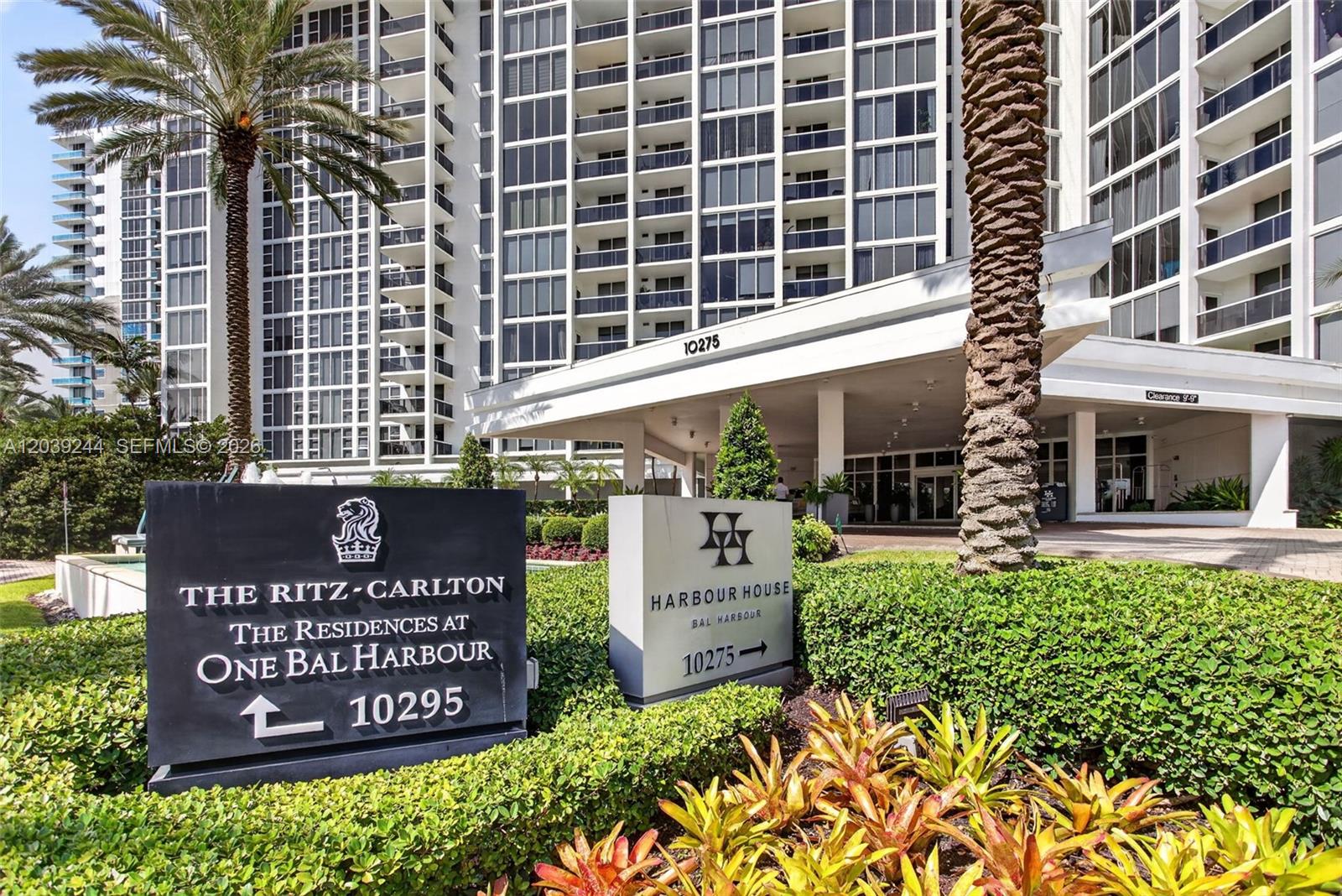 Two signs for residential buildings stand in front of a high-rise apartment complex — 10275 Collins Ave # 1521, Bal Harbour FL 33154, BAL HARBOUR, FL