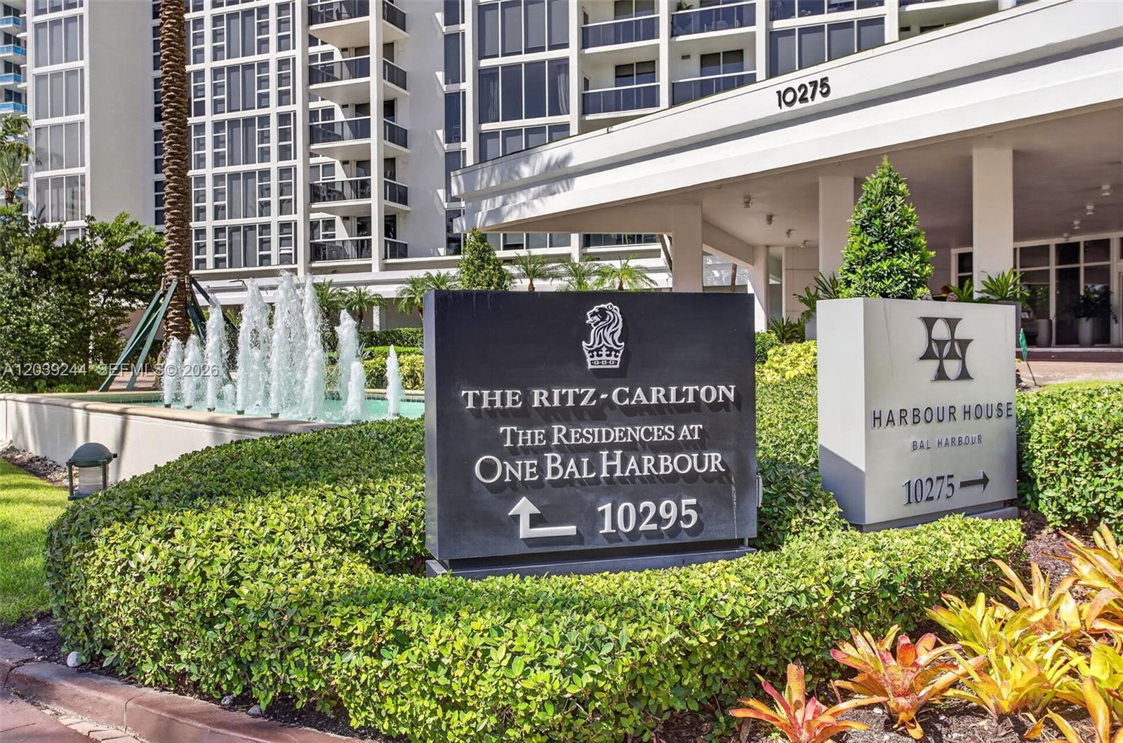 A black sign for The Ritz-Carlton stands in front of a building with fountains — 10275 Collins Ave # 1521, Bal Harbour FL 33154, BAL HARBOUR, FL