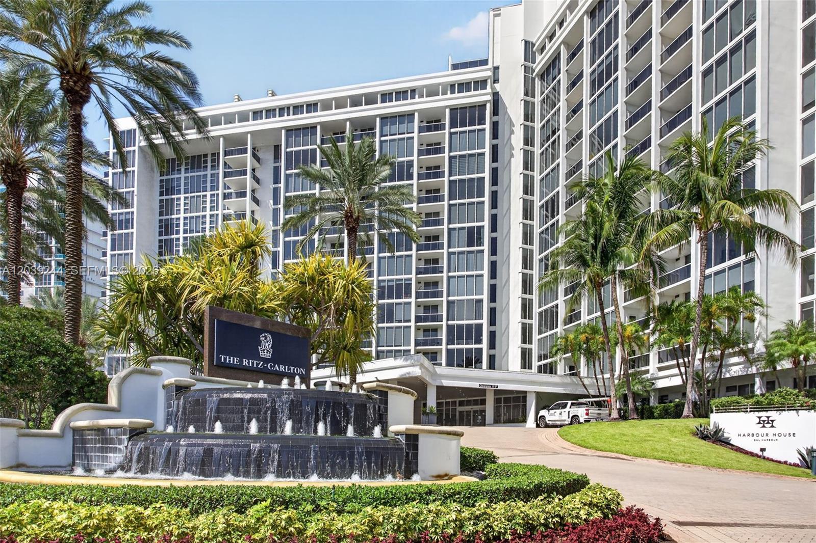 The exterior of a multi-story white building features a tiered fountain and palm trees — 10275 Collins Ave # 1521, Bal Harbour FL 33154, BAL HARBOUR, FL