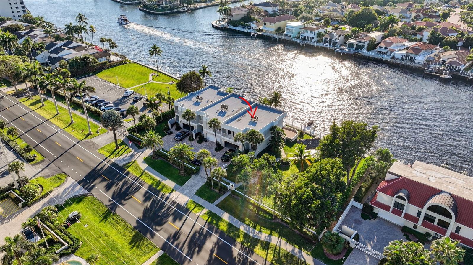 An aerial view of a waterfront townhouse with a flat roof and a red arrow — 2912 S Ocean Boulevard S, Highland Beach FL 33487, HIGHLAND BEACH, FL