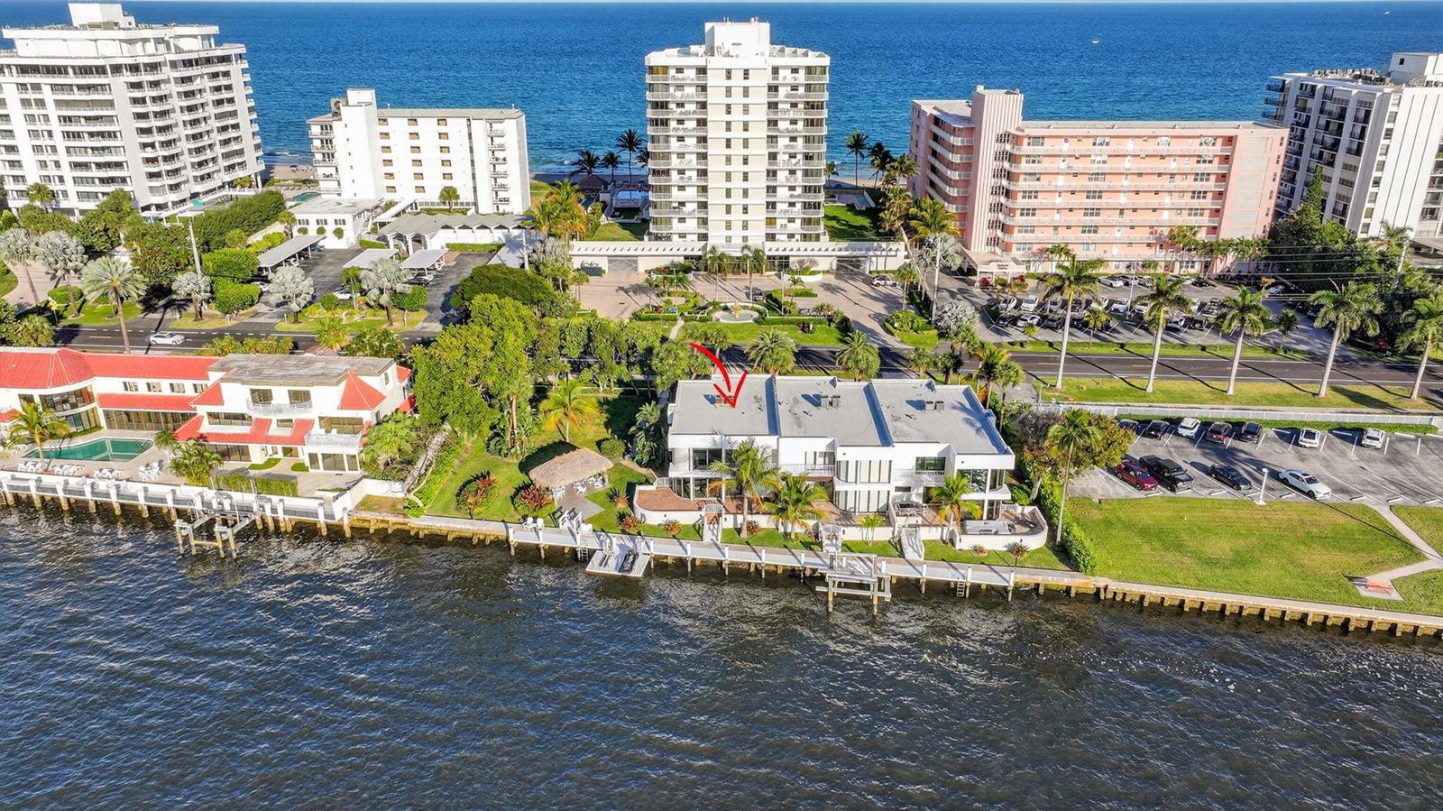 An aerial view shows a waterfront house with a flat roof and a private dock — 2912 S Ocean Boulevard S, Highland Beach FL 33487, HIGHLAND BEACH, FL