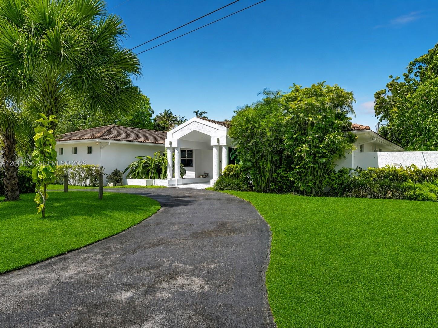 A white stucco entryway features a gabled roof supported by four columns over a tiled walkway — 7790 SW 91st Ave, Miami FL 33173, MIAMI, FL