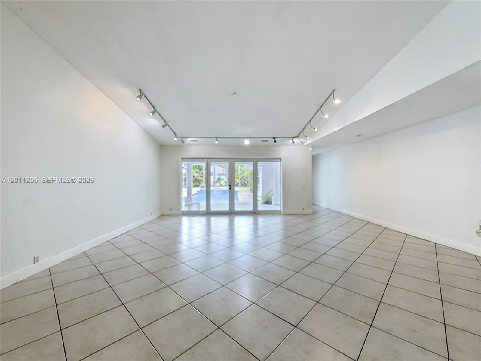 A white house with a curved driveway is surrounded by palm trees and green lawn — 7790 SW 91st Ave, Miami FL 33173, MIAMI, FL