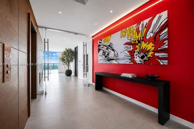 A hallway features a red wall with pop art, a black console table, and glass doors — 900 Biscayne Blvd, Miami FL 33132, MIAMI, FL