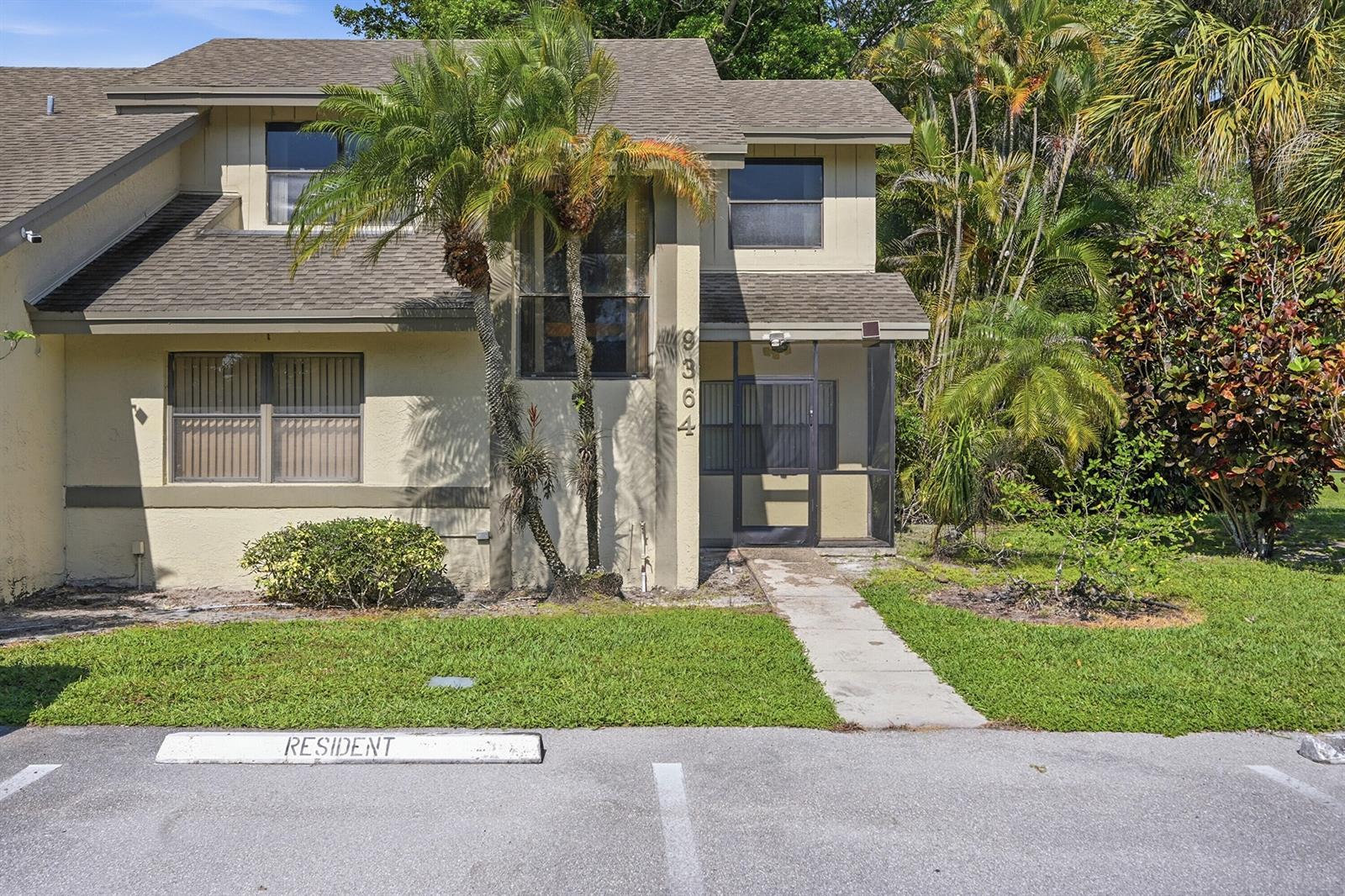 A two-story townhouse with a tan exterior, a screened-in front porch, and a palm tree — 9364 Ketay Circle # 5, Boca Raton FL 33428, BOCA RATON, FL