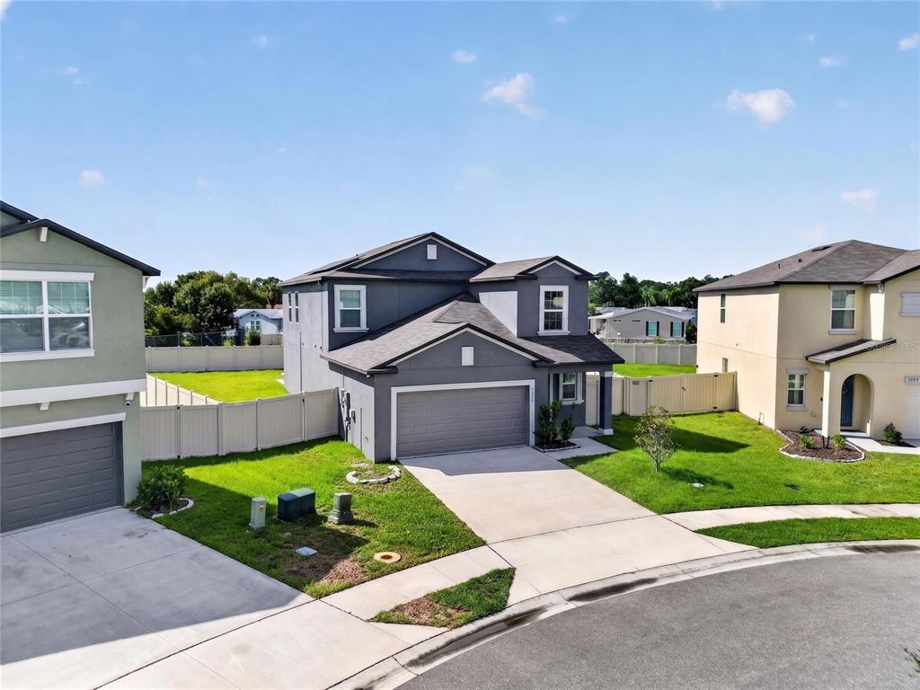 A two-story gray house with a two-car garage sits on a suburban corner lot — 1779 YELLOW TRAIL, LAKELAND, FL