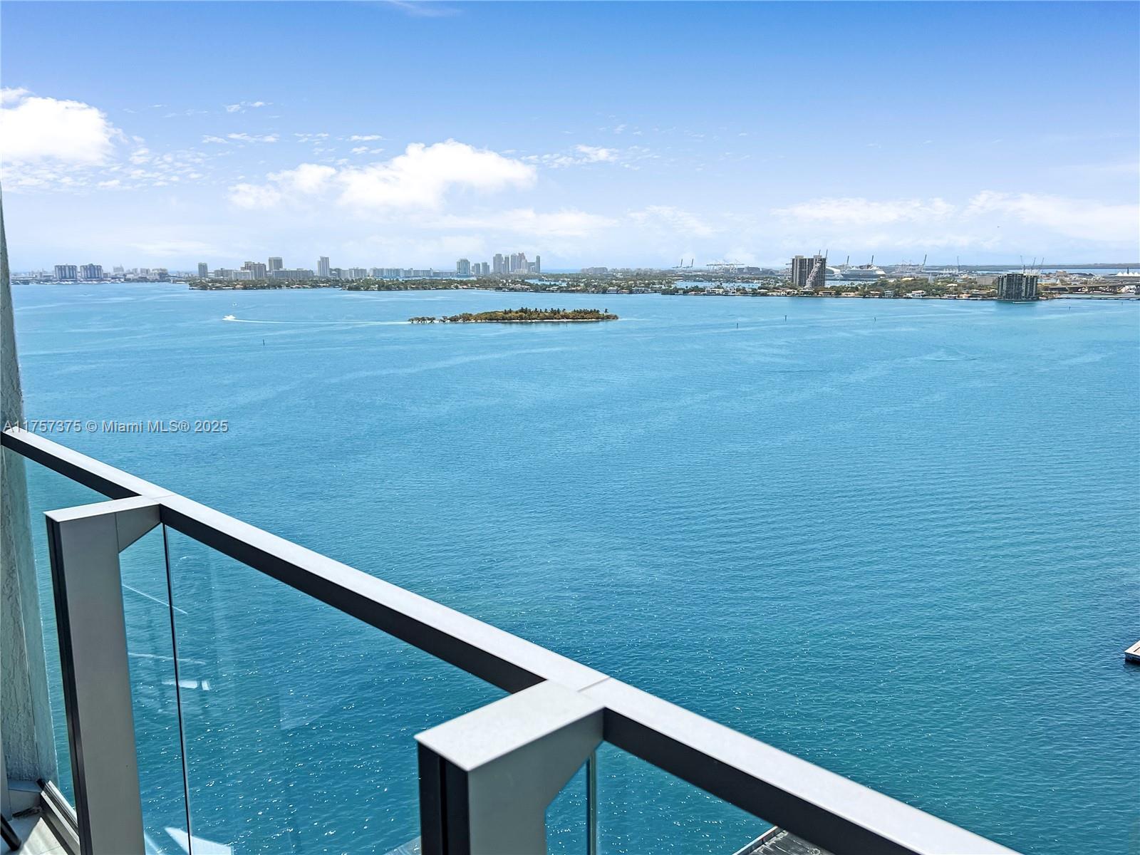 A high-angle view of a blue bay with a small island from a glass balcony — 2900 NE 7th Ave # 2008, Miami FL 33137, MIAMI, FL