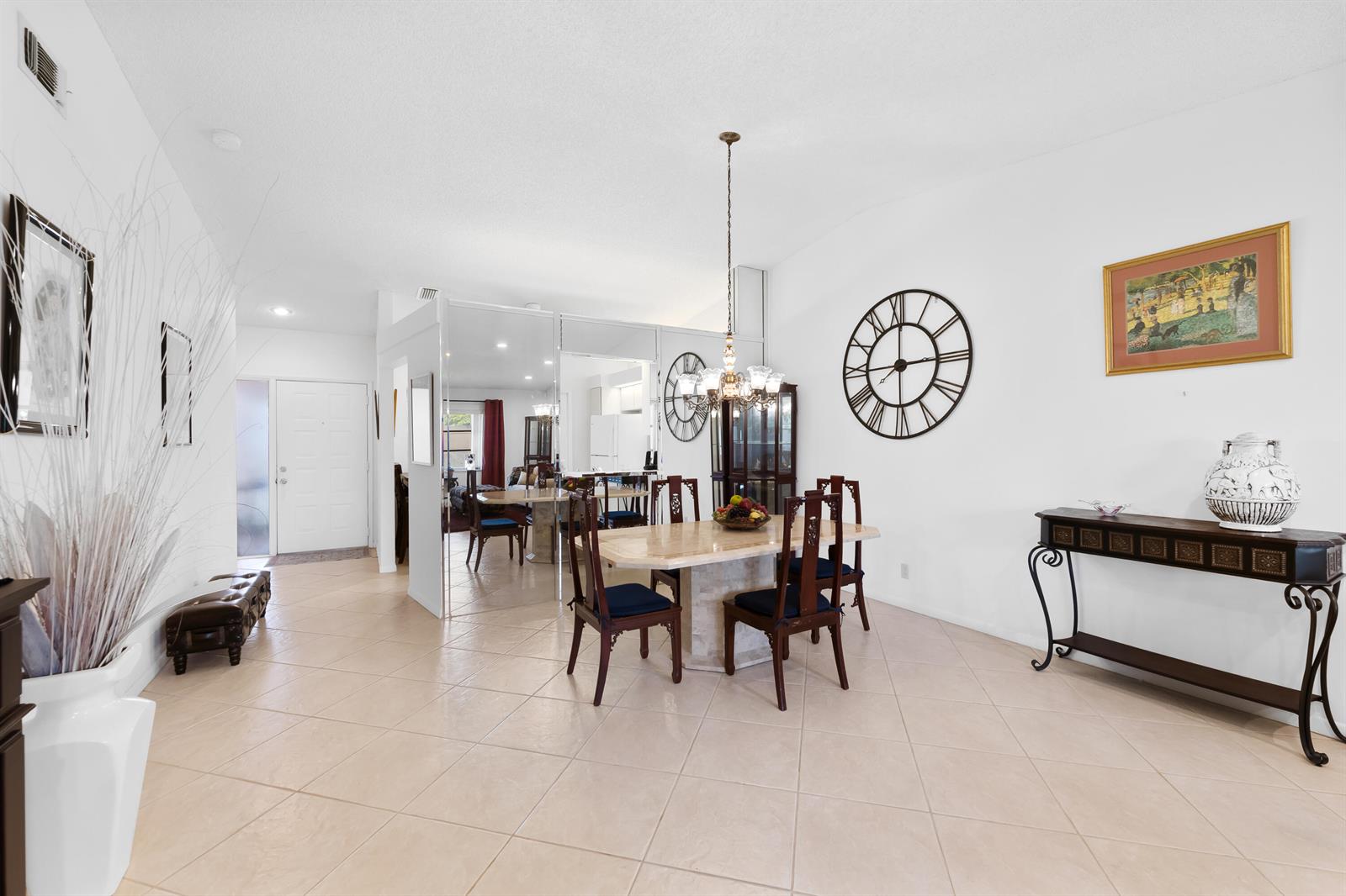 A dining room with a marble table, dark wood chairs, and a large wall clock — 8236 Summerbreeze Lane, Boca Raton FL 33496, BOCA RATON, FL