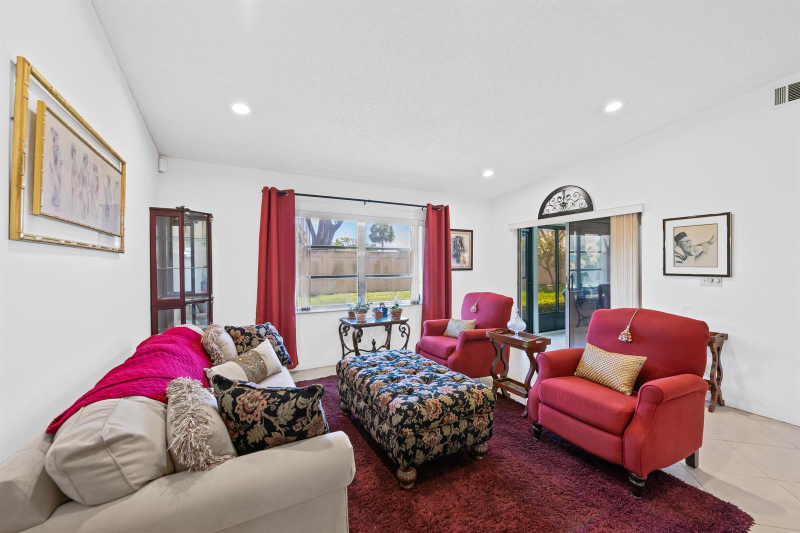 A living room features a beige sofa, two red armchairs, and a floral ottoman — 8236 Summerbreeze Lane, Boca Raton FL 33496, BOCA RATON, FL