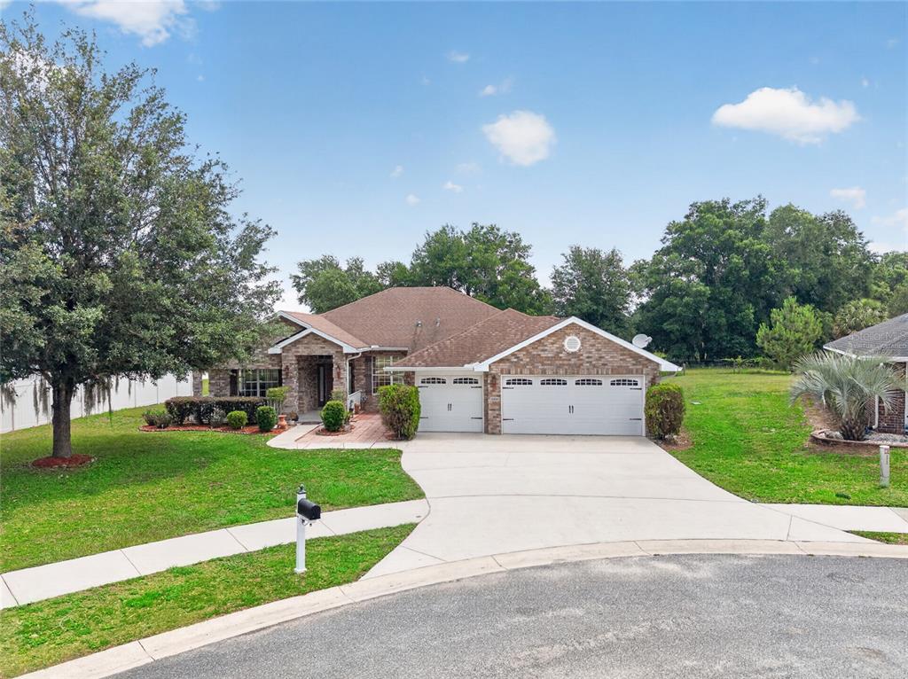 A single-story brick house with a three-car garage and a large front lawn — 4319 SW 63RD STREET, OCALA, FL
