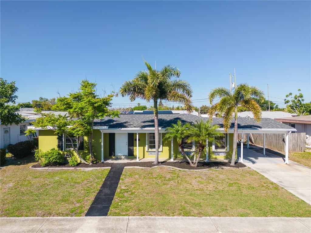 A single-story house with a green exterior, a gray roof, and two palm trees — 640 DALTON BOULEVARD, PORT CHARLOTTE, FL