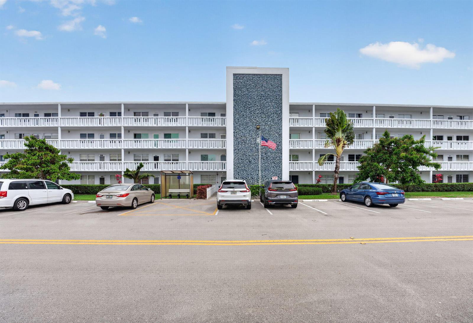 A multi-story apartment building with a central blue tiled facade and a parking lot — 1025 Ventnor # H, Deerfield Beach FL 33442, DEERFIELD BEACH, FL