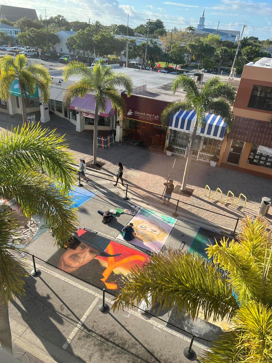 An elevated view of a street festival featuring chalk art on the pavement near shops — 511 Lucerne Avenue # 316, FL 33460, FL