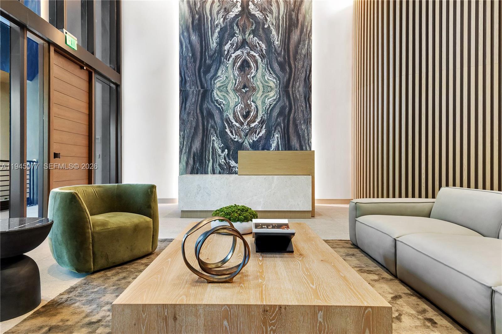 A modern lobby features a marble accent wall, a reception desk, and contemporary seating — 3034 Oak Avenue, Coconut Grove FL 33133, COCONUT GROVE, FL