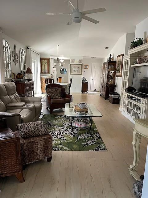 A living room features light wood flooring, a ceiling fan, and a patterned area rug — 716 DOMINGUEZ DRIVE, LADY LAKE, FL