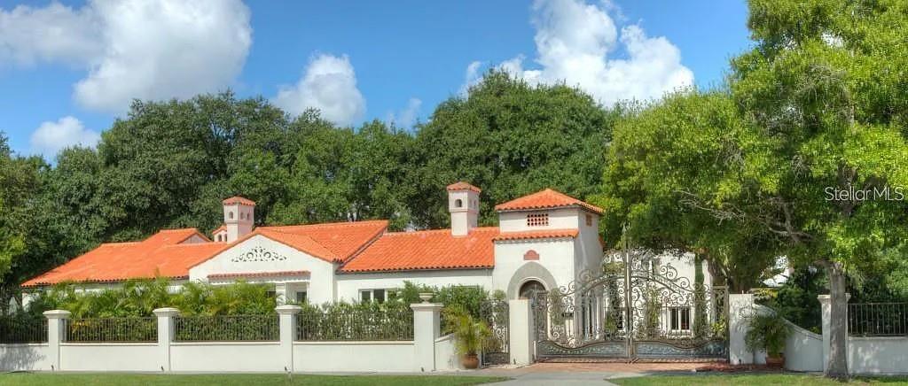 A white stucco house with a red tile roof and an ornate metal gate entrance — 100 W DAVIS BOULEVARD, TAMPA, FL