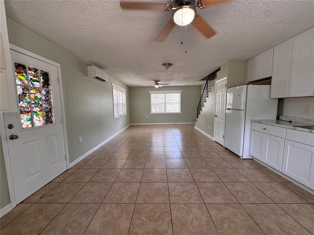 A view from a porch looking out over a yard with a large oak tree — 538 ORANGE STREET UNIT 538, MASCOTTE, FL