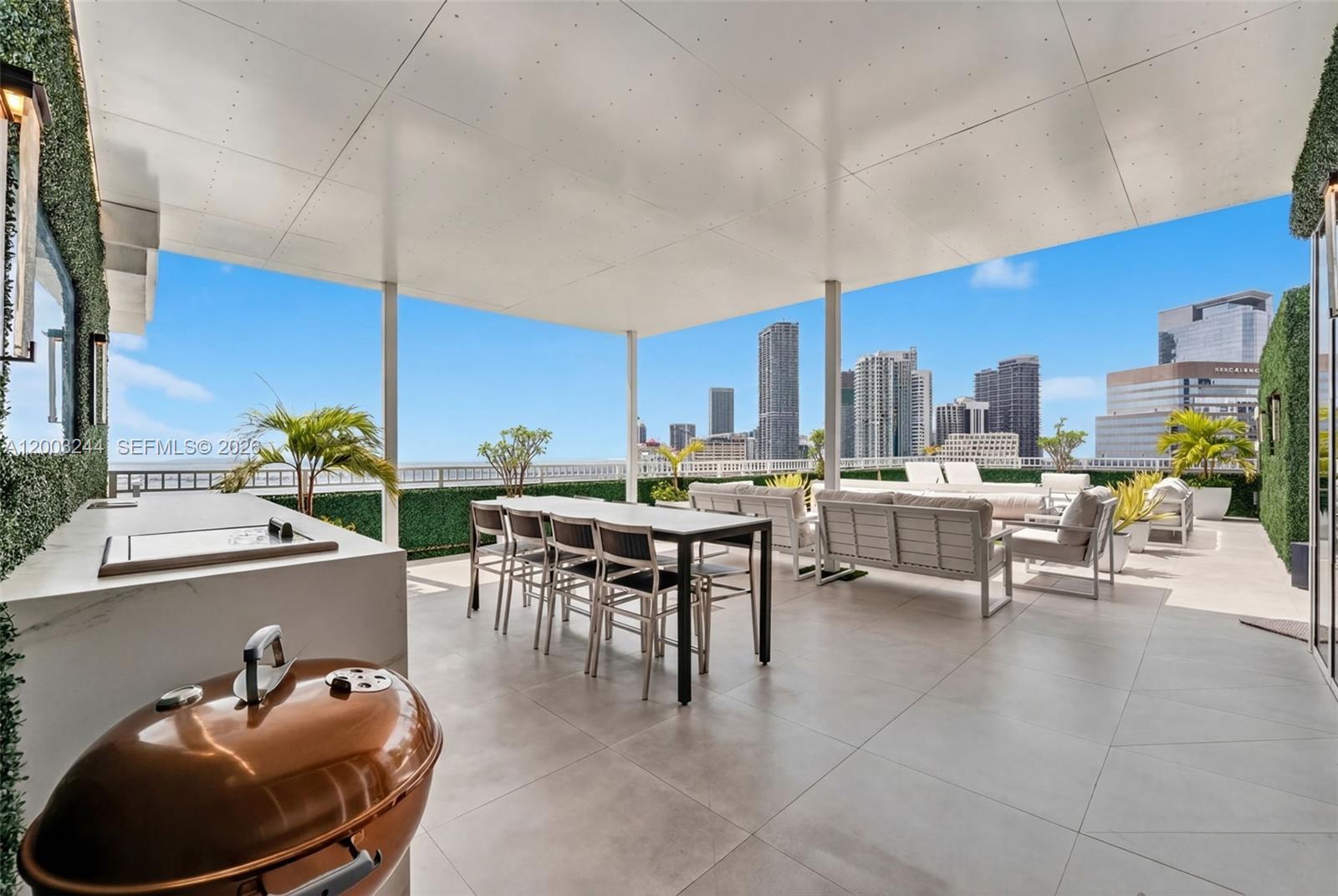 A covered outdoor terrace features a dining set, lounge seating, a grill, and city views — 801 Brickell Key Blvd, Miami FL 33131, MIAMI, FL