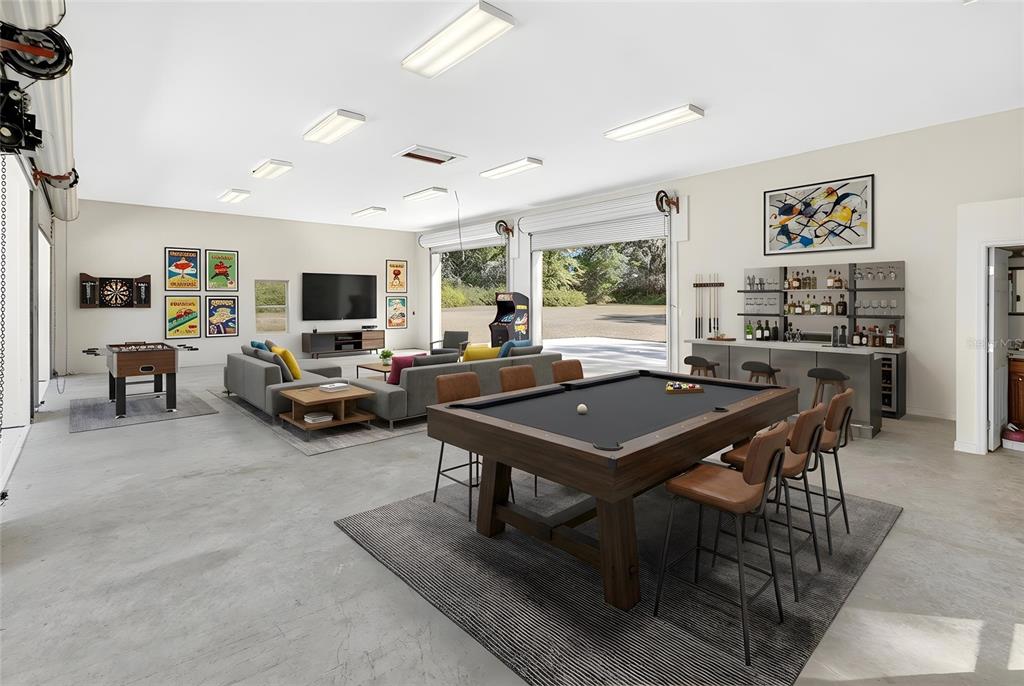 A spacious garage converted into a game room with a pool table, bar, and lounge area — 573 SE NATURE DRIVE, LAKE CITY, FL